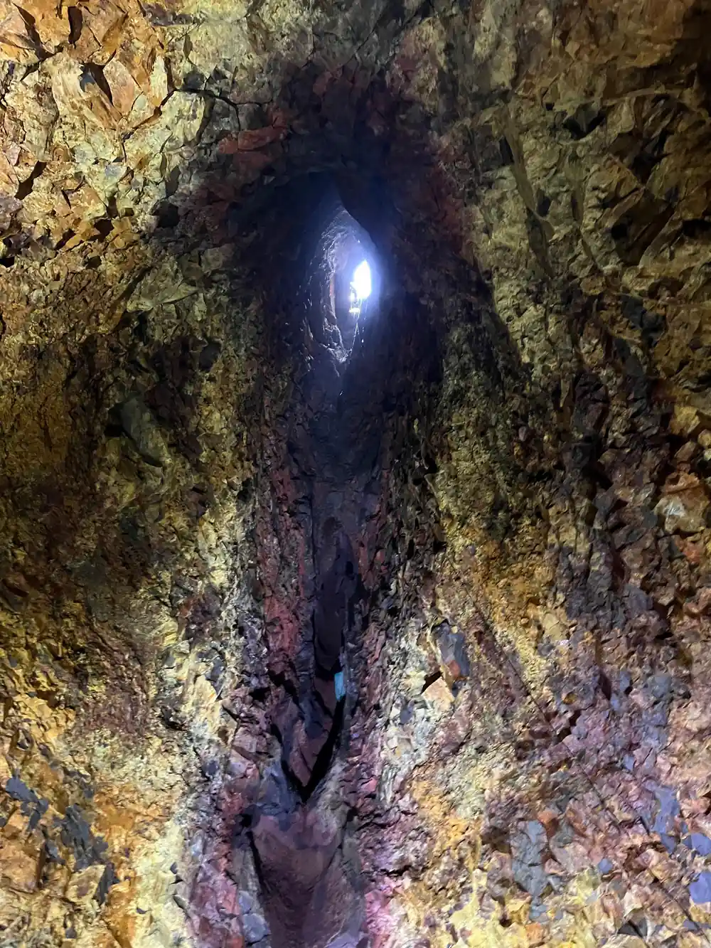 A lamp in a deep recess of the chamber wall