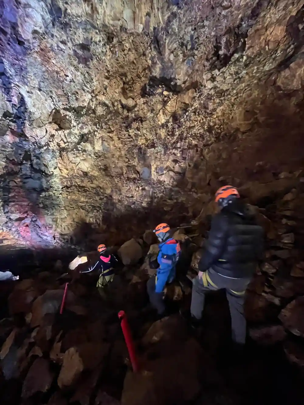Visitors climbing the rubble slope inside the chamber