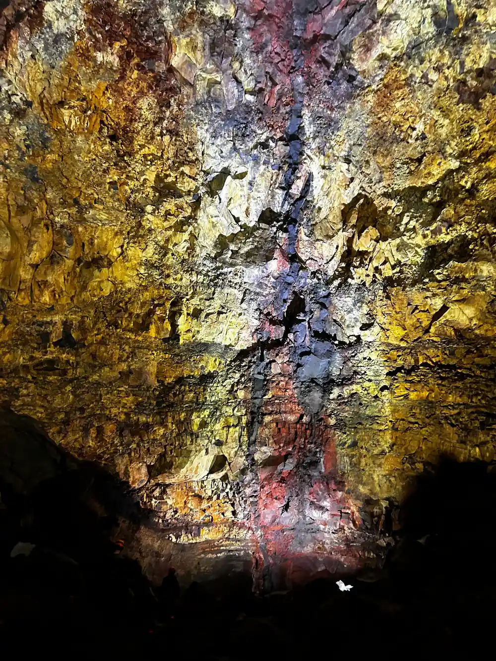 A wall of intense sulphur yellow beside a dark fracture